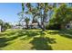 Expansive backyard with a swimming pool, mature trees, and a well-manicured lawn, perfect for outdoor activities at 6800 E Exeter Blvd, Scottsdale, AZ 85251