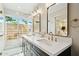 Modern bathroom showcasing a double sink vanity with a walk-in shower and views of the outdoors at 6800 E Exeter Blvd, Scottsdale, AZ 85251