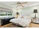 Cozy bedroom featuring a plush bed, a dark dresser, hardwood floors, and a ceiling fan at 6800 E Exeter Blvd, Scottsdale, AZ 85251