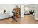 Exercise room with hardwood floors featuring an indoor rowing machine, and access to the living room at 6800 E Exeter Blvd, Scottsdale, AZ 85251