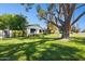 Expansive front yard showcases lush green grass and a mature tree offering ample shade at 6800 E Exeter Blvd, Scottsdale, AZ 85251