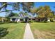 Charming single-story home featuring a well-manicured lawn, mature trees, and a welcoming walkway at 6800 E Exeter Blvd, Scottsdale, AZ 85251