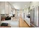 Bright kitchen with white cabinetry, stainless steel appliances, and elegant granite countertops at 6800 E Exeter Blvd, Scottsdale, AZ 85251