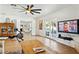 Second living room with hardwood floors, ceiling fan, and access to the outdoor area at 6800 E Exeter Blvd, Scottsdale, AZ 85251
