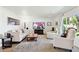 Bright living room with large windows, plush carpet, and comfortable seating arrangement, perfect for relaxation at 6800 E Exeter Blvd, Scottsdale, AZ 85251