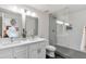 Modern bathroom with dual sinks, a glass-enclosed shower, and black and white tile at 6803 E Main St # 5503, Scottsdale, AZ 85251