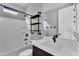 Bathroom featuring modern fixtures, white tile, and a shower/tub combo at 687 W Flintlock Way, Chandler, AZ 85286