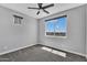 Neutral bedroom with a fan, large windows and gray carpet at 687 W Flintlock Way, Chandler, AZ 85286