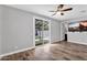 Bright bedroom featuring a sliding glass door to the backyard and wood-look flooring at 687 W Flintlock Way, Chandler, AZ 85286