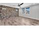 Spacious room with luxury vinyl flooring and a brick accent wall at 687 W Flintlock Way, Chandler, AZ 85286