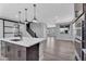 Modern kitchen with stainless steel appliances, a large island, and pendant lighting at 687 W Flintlock Way, Chandler, AZ 85286