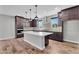 Modern kitchen with dark cabinetry, stainless steel appliances, and a large white island at 687 W Flintlock Way, Chandler, AZ 85286