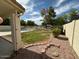 Backyard with gravel landscaping around lawn and enclosed pool at 7176 W Blackhawk Dr, Glendale, AZ 85308