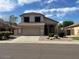 Charming two-story home features a well-maintained front yard and a two-car garage at 7176 W Blackhawk Dr, Glendale, AZ 85308