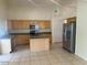 Bright kitchen with stainless steel appliances, granite countertops, and tile flooring at 7176 W Blackhawk Dr, Glendale, AZ 85308
