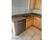 Modern kitchen sink, stainless steel dishwasher, granite countertops, and wooden cabinets at 7176 W Blackhawk Dr, Glendale, AZ 85308