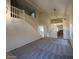 Bright, open-concept living space with high ceilings and a staircase leading to the upper level at 7176 W Blackhawk Dr, Glendale, AZ 85308