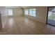 Spacious living area with tile flooring, large windows, and sliding glass door to the backyard at 7176 W Blackhawk Dr, Glendale, AZ 85308