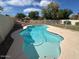 Inviting backyard pool surrounded by a patio and lush greenery, perfect for relaxation at 7176 W Blackhawk Dr, Glendale, AZ 85308