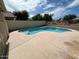 Backyard pool surrounded by a patio and a low stucco wall at 7176 W Blackhawk Dr, Glendale, AZ 85308