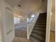 Elegant staircase with carpeted steps and white railing, connecting to the living area at 7176 W Blackhawk Dr, Glendale, AZ 85308