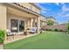 Outdoor patio area with turf grass and seating at 7234 W Aire Libre Ave, Peoria, AZ 85382