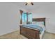 Bedroom featuring a large bed with wood frame and two windows at 7234 W Aire Libre Ave, Peoria, AZ 85382