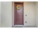 Inviting front door with a decorative wreath, showcasing curb appeal and a welcoming entrance at 7234 W Aire Libre Ave, Peoria, AZ 85382