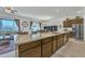 Gourmet kitchen featuring a large island with a sink, stainless steel appliances, and open layout at 7234 W Aire Libre Ave, Peoria, AZ 85382