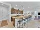 Modern kitchen boasts a large island with seating, cabinets and stainless steel appliances at 7234 W Aire Libre Ave, Peoria, AZ 85382