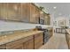 Stylish kitchen featuring granite countertops, stainless steel appliances, and ample cabinet space at 7234 W Aire Libre Ave, Peoria, AZ 85382