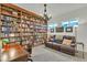 Home library with floor-to-ceiling bookshelves, warm lighting, and a leather sofa at 7234 W Aire Libre Ave, Peoria, AZ 85382