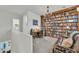 Cozy library featuring custom built-in bookshelves and a comfortable seating area at 7234 W Aire Libre Ave, Peoria, AZ 85382