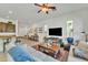 Spacious living room featuring barstool seating and an open concept kitchen/dining area at 7234 W Aire Libre Ave, Peoria, AZ 85382