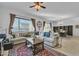 Inviting living room with a large couch, ceiling fan, and an elegant area rug at 7234 W Aire Libre Ave, Peoria, AZ 85382