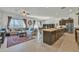 Open-concept floor plan featuring a spacious living area and kitchen island with barstool seating at 7234 W Aire Libre Ave, Peoria, AZ 85382