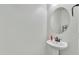A simple pedestal sink and oval mirror offer a clean and classic powder room at 7234 W Aire Libre Ave, Peoria, AZ 85382