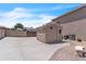 Large concrete driveway leads to a backyard shed, offering practical storage space, with privacy wall at 7524 E Leland Cir, Mesa, AZ 85207