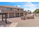 Spacious backyard featuring a built-in BBQ, brick patio, and desert landscaping, perfect for outdoor entertaining at 7524 E Leland Cir, Mesa, AZ 85207