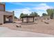 Landscaped backyard featuring patio, outdoor kitchen, pergola and desert landscaping creating a tranquil outdoor space at 7524 E Leland Cir, Mesa, AZ 85207