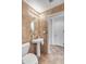 Powder bathroom featuring pedestal sink, decorative mirror and wainscoting detail at 7524 E Leland Cir, Mesa, AZ 85207