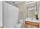 Cozy bathroom featuring a shower with curtain, toilet, and vanity sink at 7524 E Leland Cir, Mesa, AZ 85207