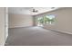 Spacious bedroom features neutral walls and carpeting with a sliding door to a balcony at 7524 E Leland Cir, Mesa, AZ 85207