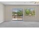 Bedroom with carpet, neutral paint, and sliding glass doors leading to the patio at 7524 E Leland Cir, Mesa, AZ 85207