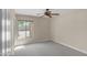 This bedroom features neutral walls, carpet, and a window providing natural light at 7524 E Leland Cir, Mesa, AZ 85207