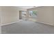 Bedroom with sliding closet doors features neutral paint, carpeting, and window at 7524 E Leland Cir, Mesa, AZ 85207