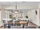 Open dining area with chandelier, and views to living room and staircase at 7524 E Leland Cir, Mesa, AZ 85207