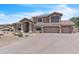 Two-story home with a three-car garage and desert landscaping. Well maintained property with great curb appeal at 7524 E Leland Cir, Mesa, AZ 85207