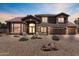 Elegant two-story home featuring a tile roof, large windows, balcony, and a three-car garage at 7524 E Leland Cir, Mesa, AZ 85207