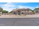 Charming two-story home with a well-manicured front yard, mature trees, and a spacious three-car garage at 7524 E Leland Cir, Mesa, AZ 85207